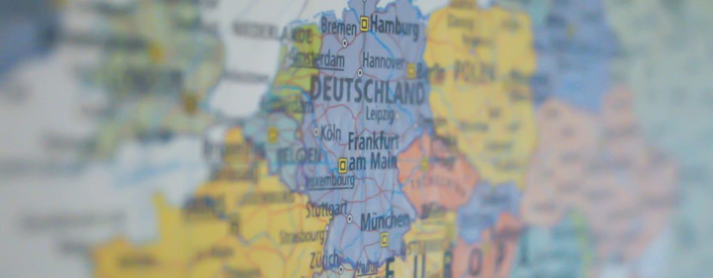 Close-up view of Germany on a colorful world map showing major cities.